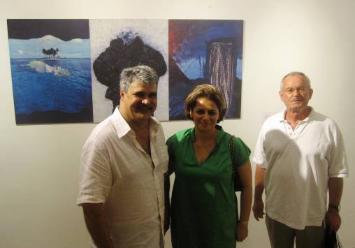 Collectors Farouk and Aliya Khan with artist Askandar Unglehrt with his Liberty – Equality – Fraternity, 2009, Hand manipulated magazine prints, enlarged on canvas (permanent ink) and mounted on board, 77.5 x 57.5cm (triptych). 